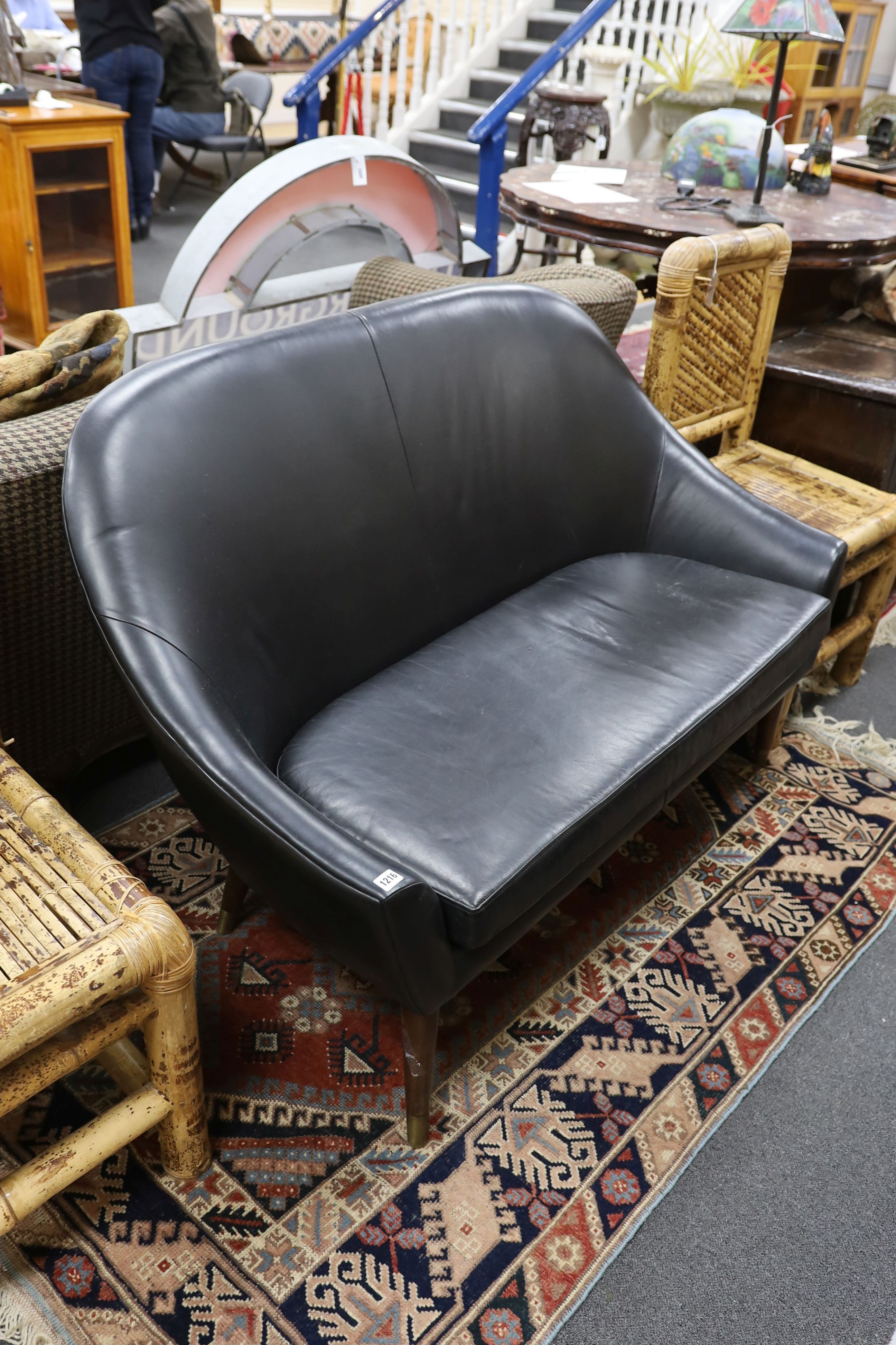 A mid century design black leather tub framed settee, length 136cm, depth 76cm, height 89cm